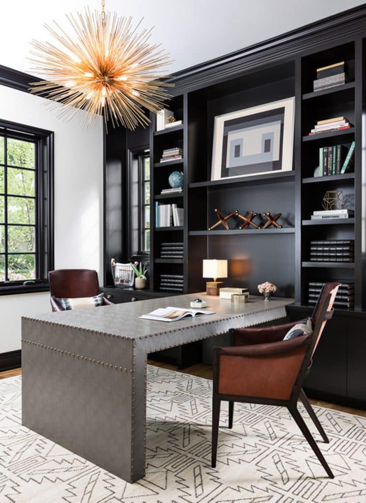 a home office with table chairs and buit in storing shelves