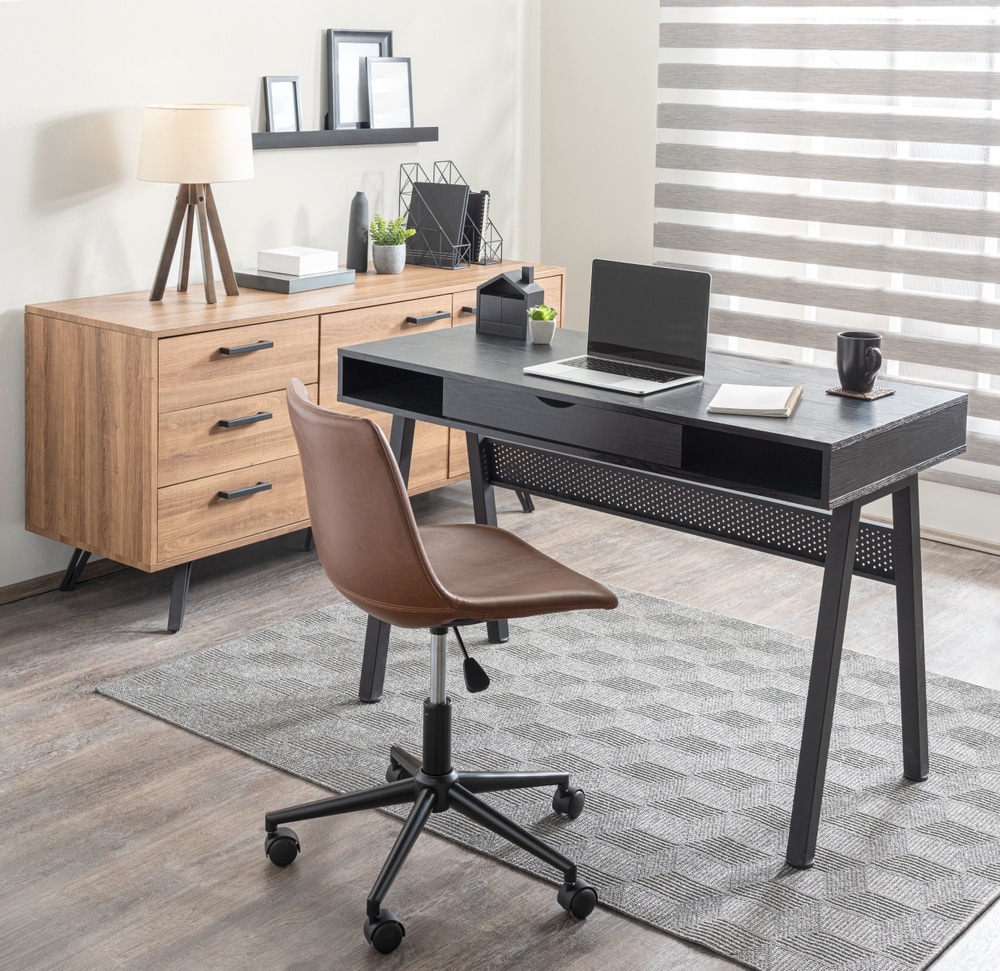 Streamlined Modern Home Office With A Perforated Black Desk Mid century