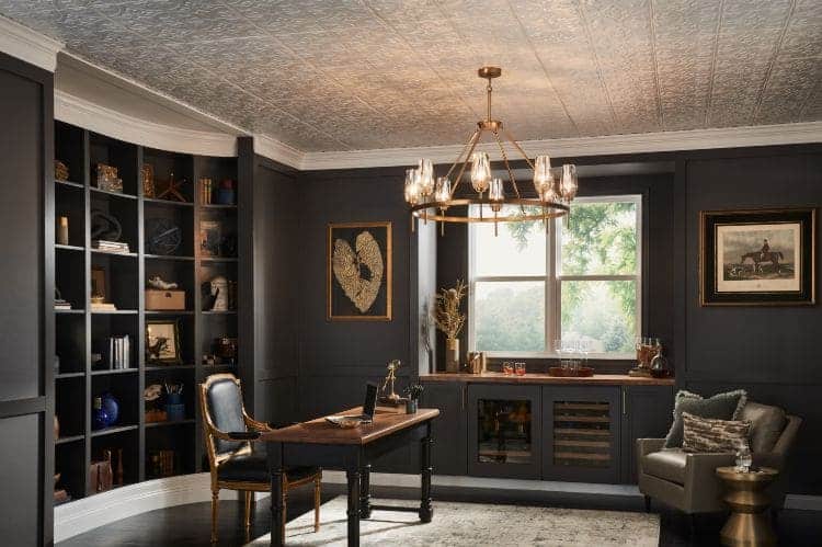 chandelier lights wokring desk chair and books in shelves in black thrmed office