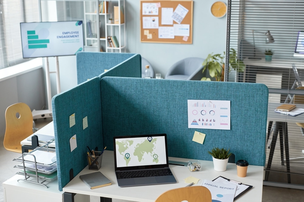 High angle view at office interior with workplaces separated by partition walls in neutral blue tones, cozy space