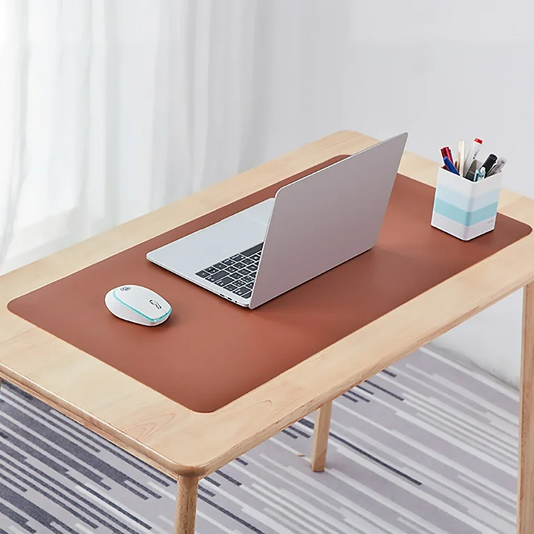 brown desk mat a laptop and mouse placed on it