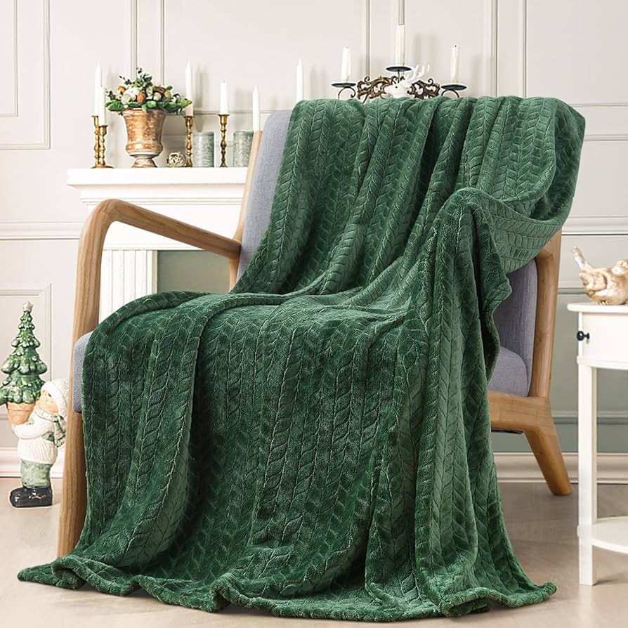 green fleece throw blanket on a chair