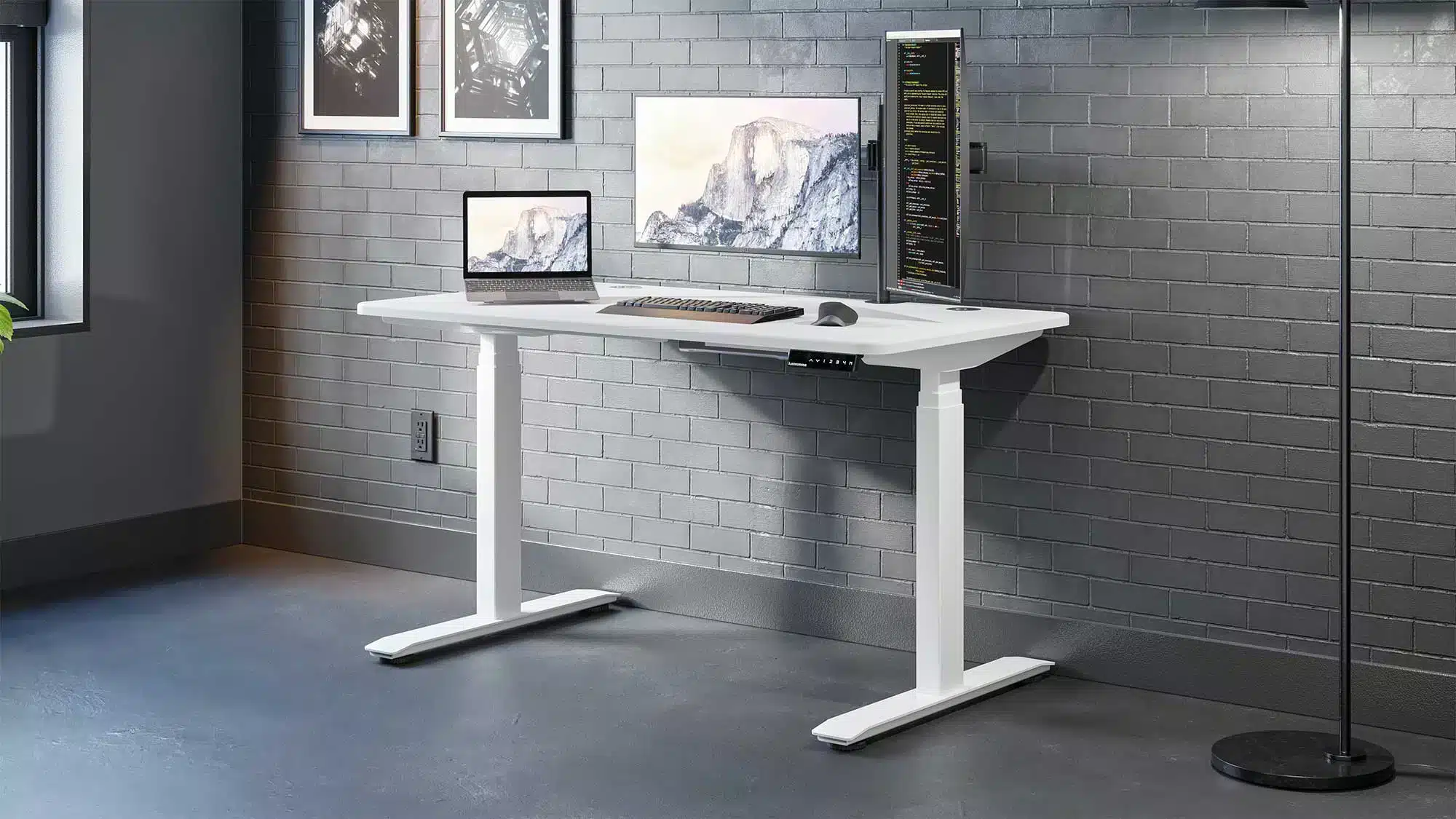 white colored autonomous desk a monitor placed on desk