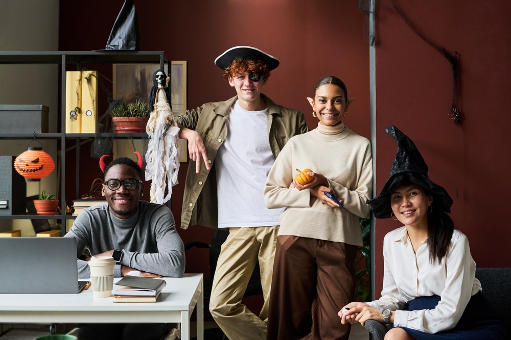 Group Of Happy Young Intercultural Office Managers In Halloween Costumes