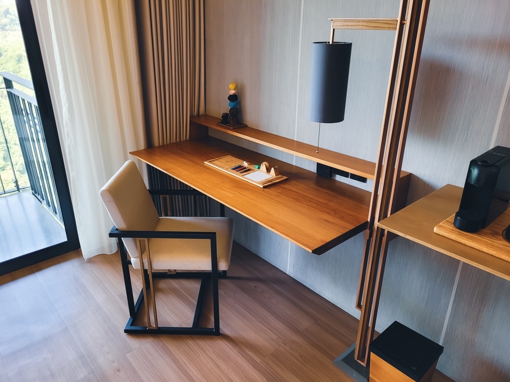 Minimalist work area design with wooden chairs and work desks mounted to the wall