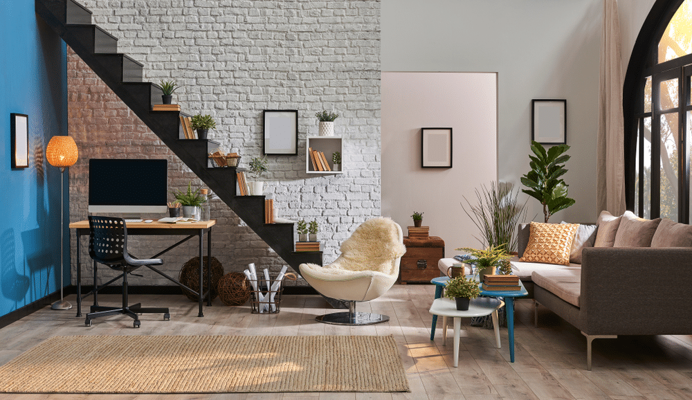 Modern living room white brick wall wooden desk and desktop under black stair