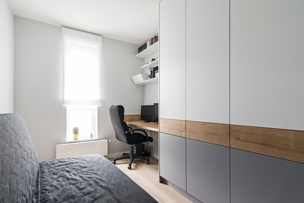 home office nook in corner alongside closet